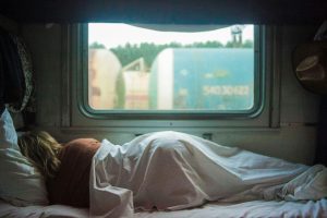 A woman sleeping in a trailer.