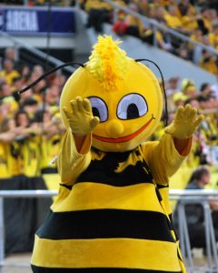 A bee mascot raising its hands to the viewer.
