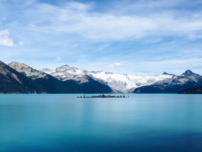 A body of water beside a mountain range.