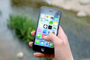 A person holding an iPhone.