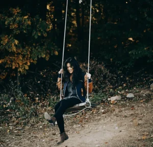 Alexa Fernando sitting on a swing.
