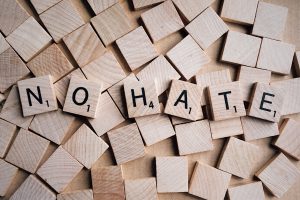 Scrabble pieces spelling out No Hate.