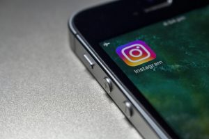 Close-up shot of a phone with the Instagram app on the home screen.