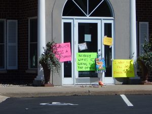 Walter Palmer's clinic with activist placards on the door.