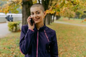 A woman in a purple jacket on a phone call.