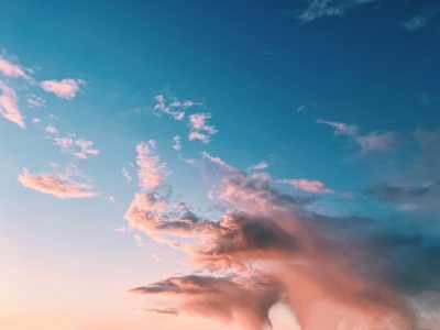 Sunset with pink clouds in blue sky.