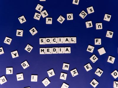 Scrabble tiles spelling 'Social Media' on a blue background