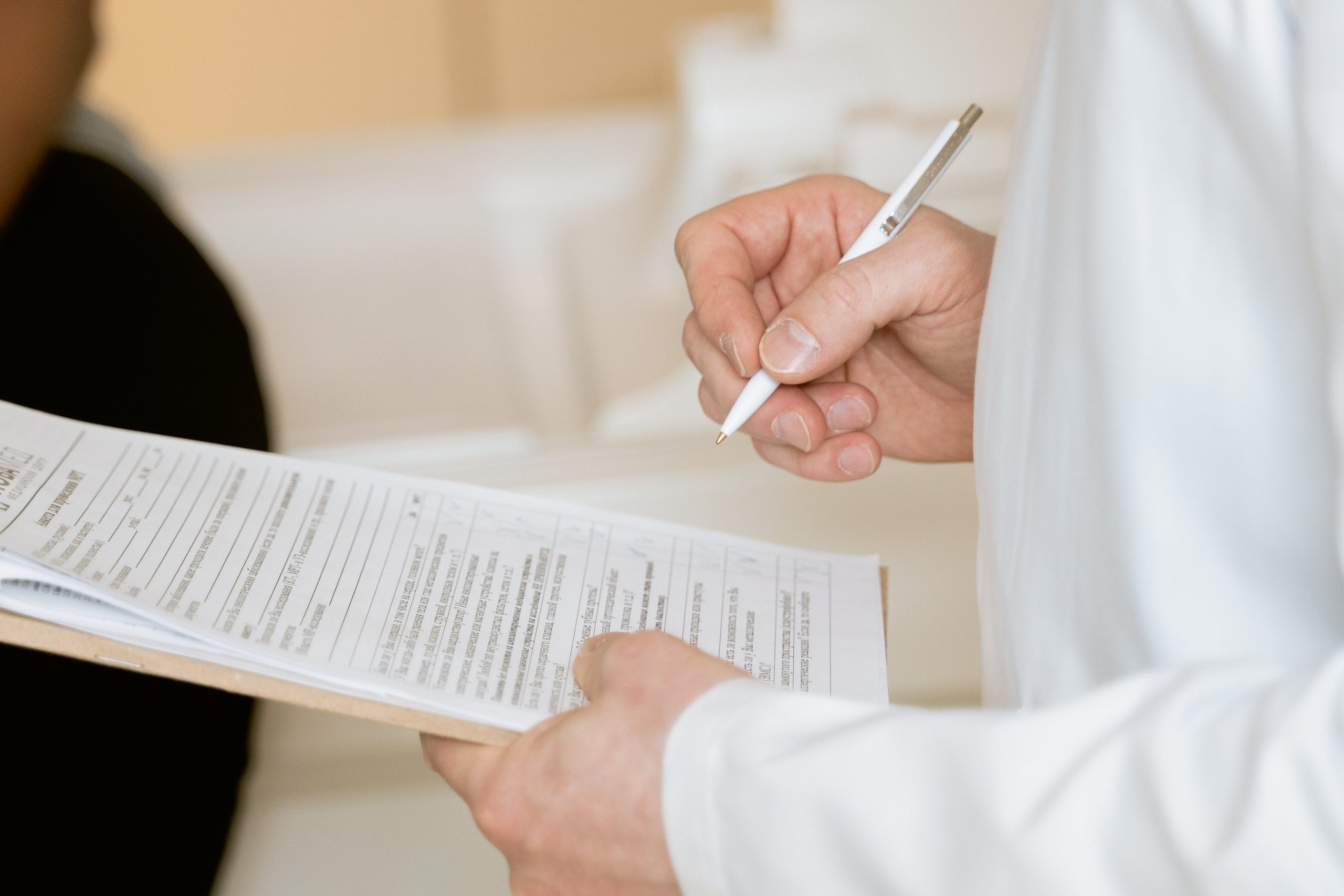 An individual holding a checklist/application