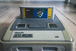 A picture of a Super Mario World cartridge inserted into a Super Nintendo Entertainment System. 