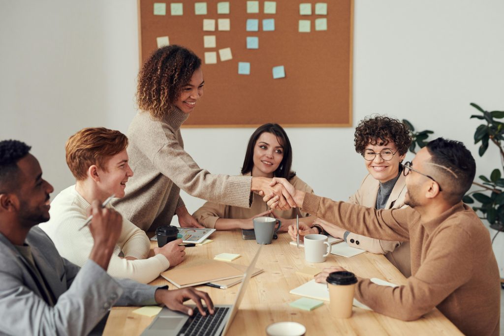 People sitting in a boardroom. 