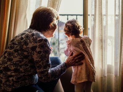 Grandma and Granddaughter at window