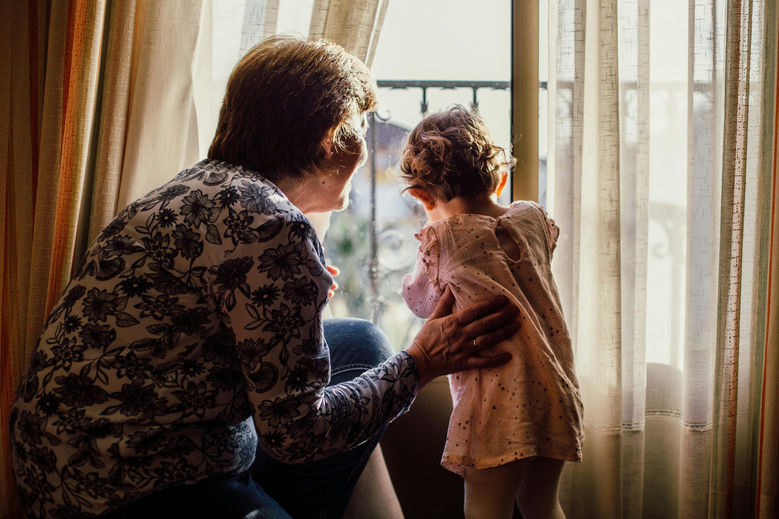 Grandma and Granddaughter at window
