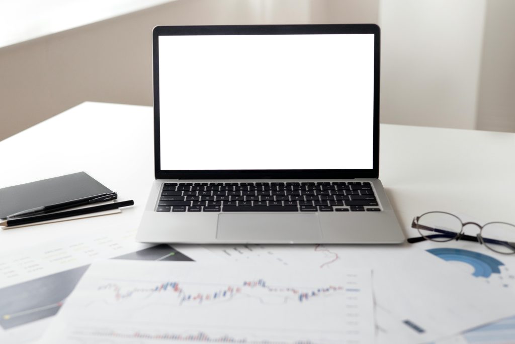 A grey laptop with a blank white screen. 