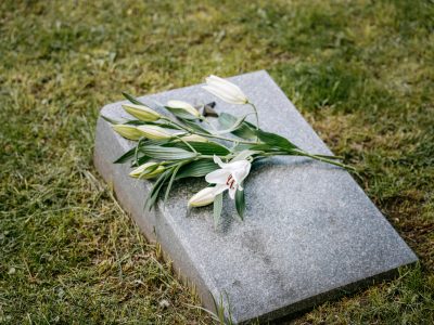 A Gravestone with flowers on top of it