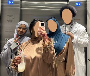 Four cousins wearing Islamic clothing, three of them have their faces blurred out and one of them doesn't.