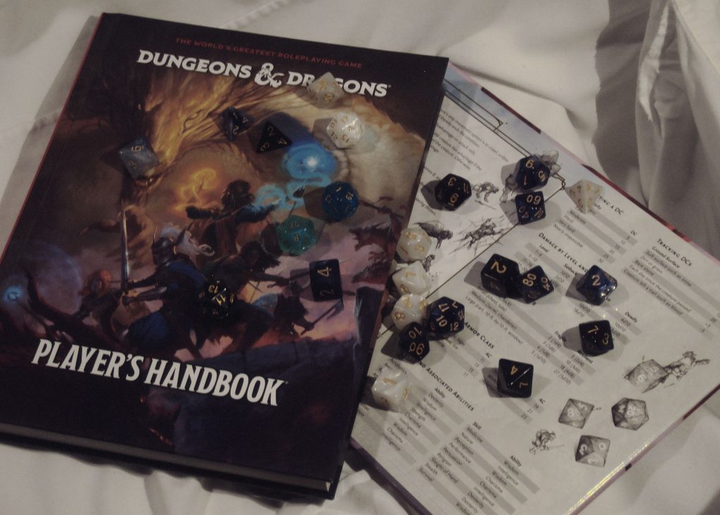 A photo of the author's Player's Handbook, DM Screen, and dice sets