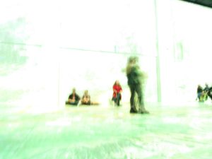 Blurred and over-exposed image of people in a hallway