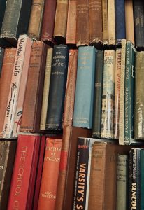 Many old books stacked vertically
