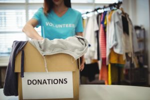 Photo of a volunteer sorting through donated clothes