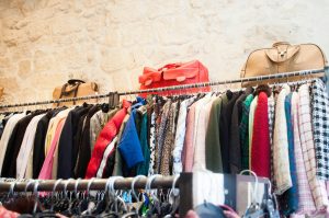 Photo of a rack of clothes at a thrift store.