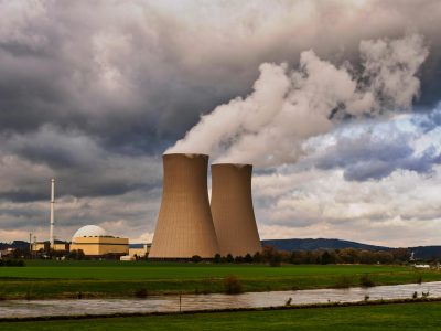 2 nuclear power plants in the middle with smoke coming out of them