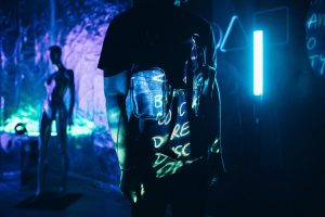 scifi-projection A man standing in the darkness, surrounded by vibrant lights.