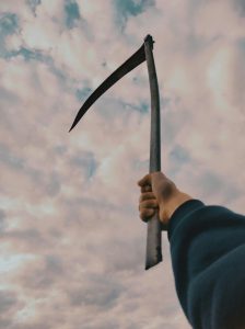 A Person Holding a Scythe