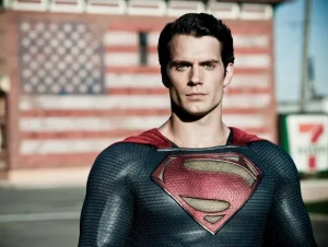 Henry Cavill as the Man of Steel standing with an American flag in the background