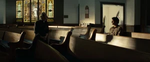 Clark talking to a Priest, deciding to turn himself in to the American military