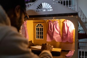 A lit up dollhouse.
