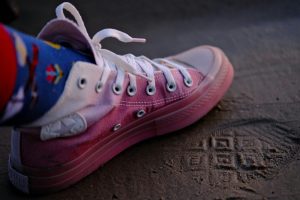 A sneaker in sand.