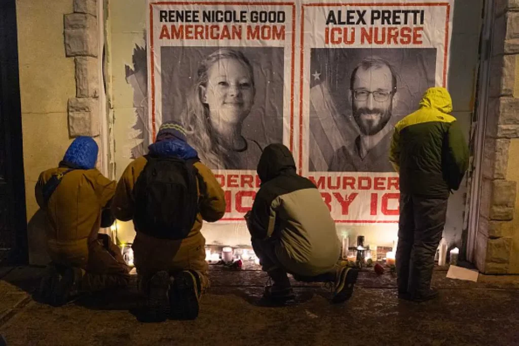 People attend a candlelight vigil this week that was organized by health care workers and that took place at the site where Alex Pretti was killed in Minneapolis.