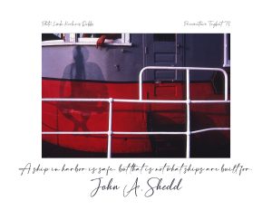 Red tugboat cast with a shadow of a figure sitting on a railing