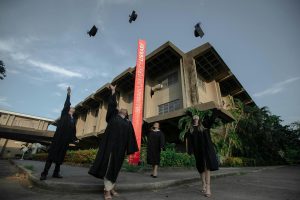 A group of graduates throwing their caps in the air.