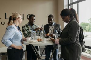 A group of people talking around a table.