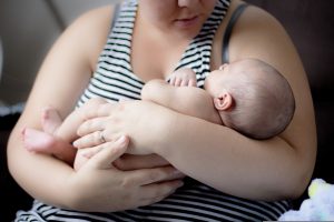 A woman holding her infant child.