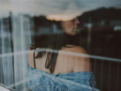 A woman looking back towards a window.