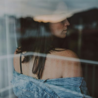 A woman looking back towards a window.
